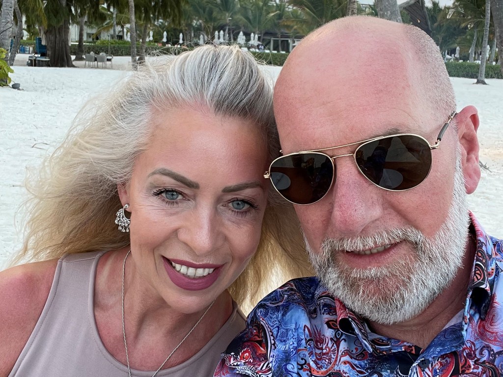 Photo of CEO Samantha Bennett and her husband, smiling at the beach.
